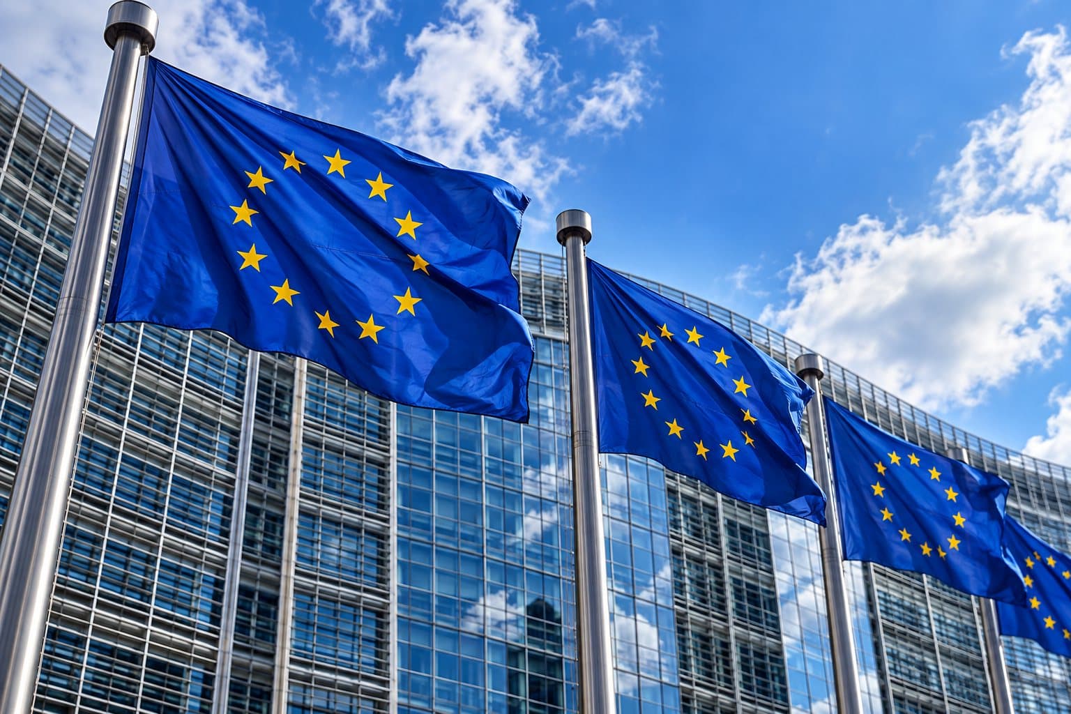 European Union flags in front of a glass office building